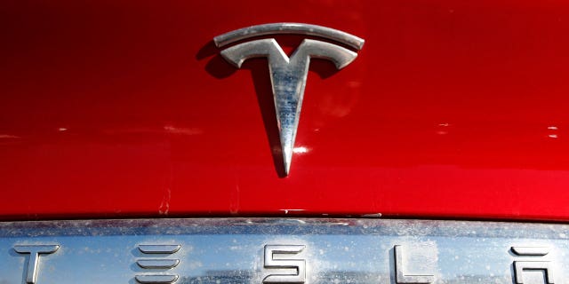 The Tesla company logo sits on an unsold 2020 Model X at a Tesla dealership in Littleton, Colorado, on Feb. 2, 2020.