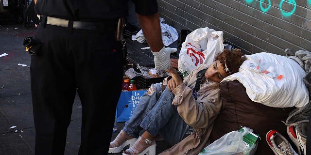 A paramedic helps a homeless woman in the Tenderloin district of San Francisco in California, United States on Oct. 9, 2022. Homelessness and crime have been persistent problems in the Silicon Valley city.