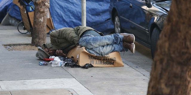 Homeless persons are seen sleeping on the street of Tenderloin during the state of emergency.