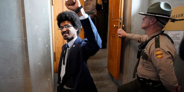 FILE: Rep. Justin Pearson, D-Memphis, raises his fist after visiting with supporters in the gallery of the House chamber Thursday, April 6, 2023, in Nashville, Tenn.