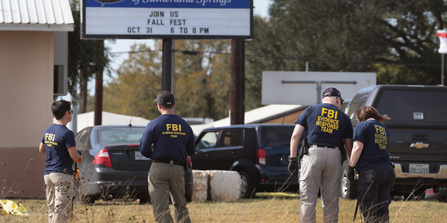 Law enforcement officials are seen outside the First Baptist Church of Sutherland Springs on Nov. 6, 2017, the day after the shooting.
