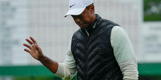 Tiger Woods waves after weather delayed the second round of the Masters golf tournament at Augusta National Golf Club on Saturday, April 8, 2023, in Augusta, Georgia.