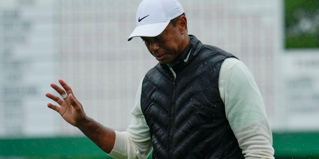 Tiger Woods waves after weather delayed the second round of the Masters golf tournament at Augusta National Golf Club on Saturday, April 8, 2023, in Augusta, Georgia.