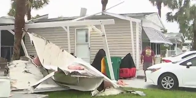 A Florida residents surveys the wreckage after a tornado swept through his community.