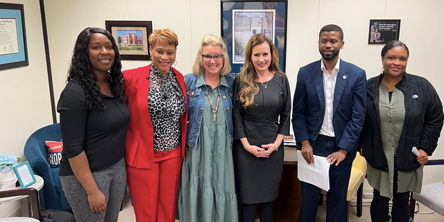North Carolina state Rep. Tricia Cotham, third from right, is shown after a discussion with parents from Charlotte on education.