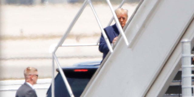 Former U.S. President Donald Trump boards his plane, at the Palm Beach International Airport, after his indictment by a Manhattan grand jury following a probe into hush money paid to porn star Stormy Daniels, in West Palm Beach, Florida, U.S., April 3, 2023. 