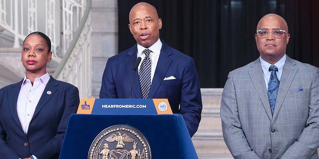 New York City Mayor Eric Adams (L) and New York City Police Department (NYPD) Commissioner Keechant Sewell (R) make a public safety-related announcement ahead of former US President Donald Trump's arrival