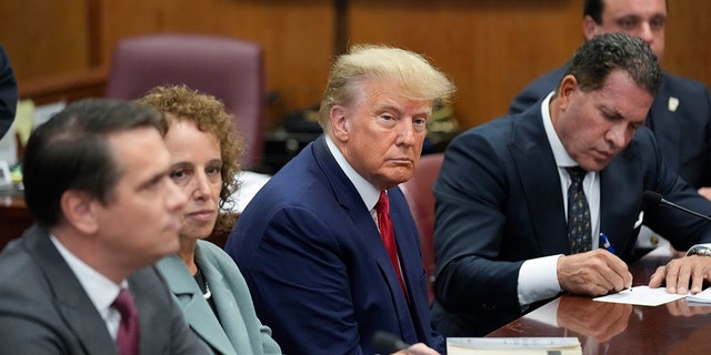 NEW YORK, NEW YORK - APRIL 04: Former U.S. President Donald Trump sits at the defense table with his defense team in a Manhattan court on April 4, 2023, in New York City. Trump was arraigned during his first court appearance today following an indictment by a grand jury that heard evidence about money paid to adult film star Stormy Daniels before the 2016 presidential election. With the indictment, Trump becomes the first former U.S. president in history to be charged with a criminal offense. 