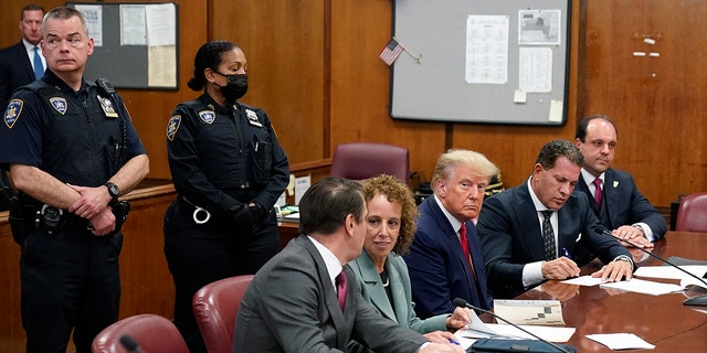 Former President Donald Trump sits with his defense team in a Manhattan court during his arraignment on April 4, 2023, in New York City.