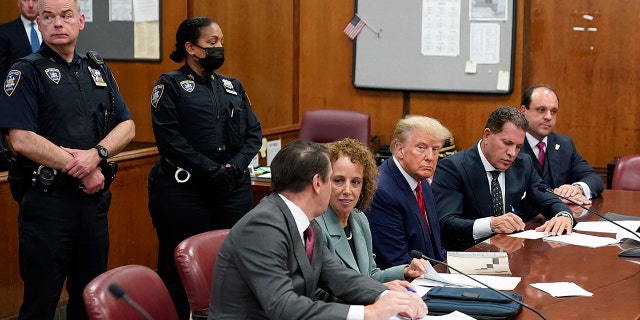 Former President Donald Trump sits with his defense team in a Manhattan court during his arraignment on April 4, 2023, in New York City.