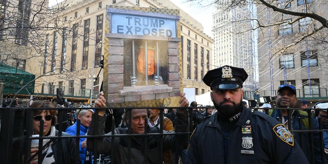 Opponents of former President Donald Trump protest outside the Manhattan District Attorney's Office in New York on April 4, 2023.