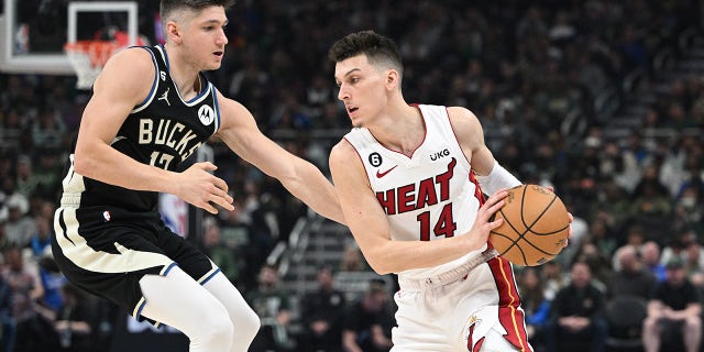 Apr 16, 2023; Milwaukee, Wisconsin, USA; Miami Heat guard Tyler Herro (14) drives against Milwaukee Bucks guard Jrue Holiday (21) in the first half during game one of the 2023 NBA Playoffs at Fiserv Forum.