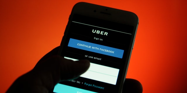 An iPhone with an Uber application login screen