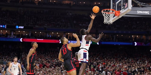 Adama Sanogo #21 of the Connecticut Huskies shoots the ball against Jaedon LeDee #13 of the San Diego State Aztecs during the first half of the NCAA Men's Basketball Tournament National Championship game at NRG Stadium on April 3, 2023 in Houston Texas.