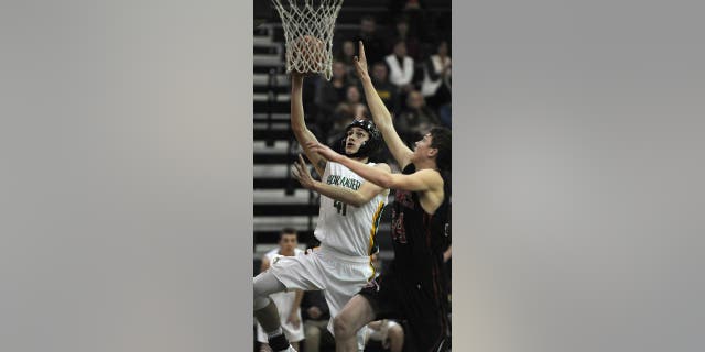 Floyd Central player Connor Sturgeon, left, shoots for two points against Brownstown Central at Floyd Central High School, Feb. 16, 2016.