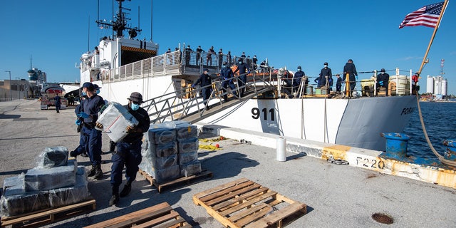 crews stacking bales of cocaine