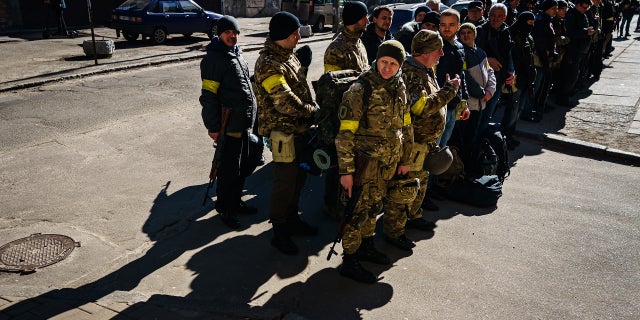 The soldier in the video was wearing a yellow armband similar to the one seen here worn by Ukraine's Territorial Defense Units in February 2022.