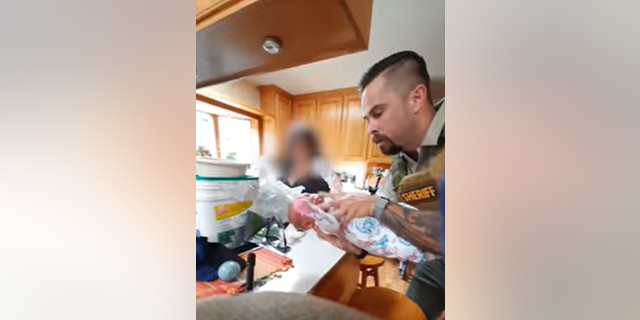 California sheriff's detective saves aspirating baby's life with CPR: video Detective holding baby during CPR