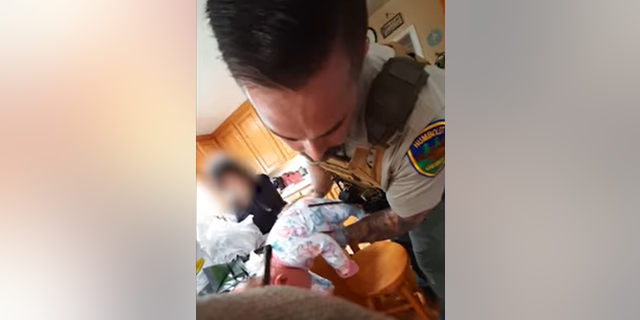 Detective performing CPR on baby