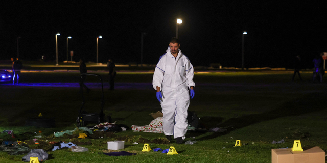 An Israeli policeman inspects the site of an attack in Tel Aviv on April 7, 2023. - One man was killed and four people were wounded in an attack in central Tel Aviv, Israeli rescue services said, updating a previous casualty toll of two injured.