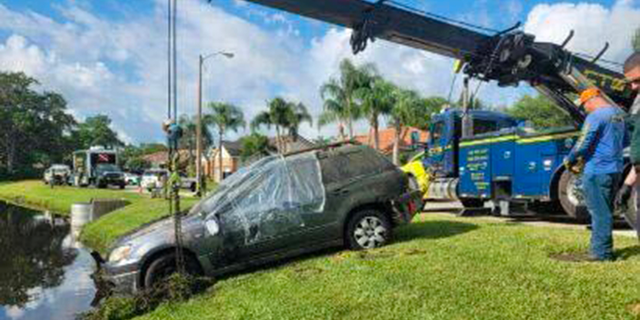 A dive and recovery team in Florida assisted in pulling a car from a retention pond on Friday that belonged to a man who has been missing since 2006 and found human bones inside.