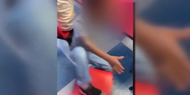 One video appears to show the individual kicking a child's chair, forcing the child to fall on the ground.