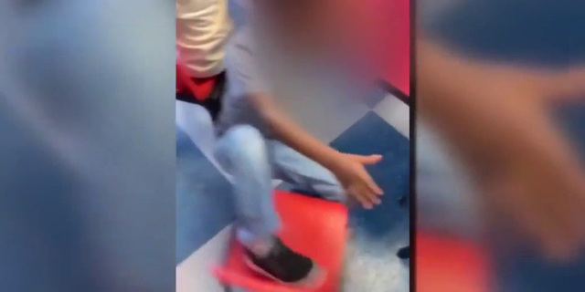 One video appears to show the individual kicking a child's chair, forcing the child to fall on the ground.