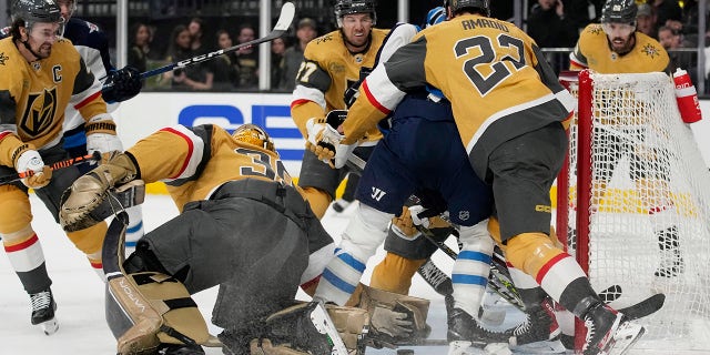 Vegas Golden Knights goaltender Laurent Brossoit (39) grabs the puck against the Winnipeg Jets during the first period of Game 1 of an NHL hockey Stanley Cup first-round playoff series Tuesday, April 18, 2023, in Las Vegas.