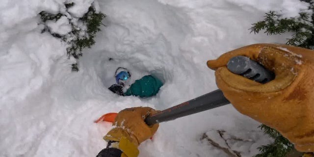 Francis Zuber working to clear snow out from under him.