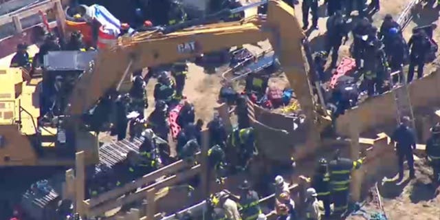Authorities search for two workers trapped in a trench at John F. Kennedy International Airport in New York City, New York.