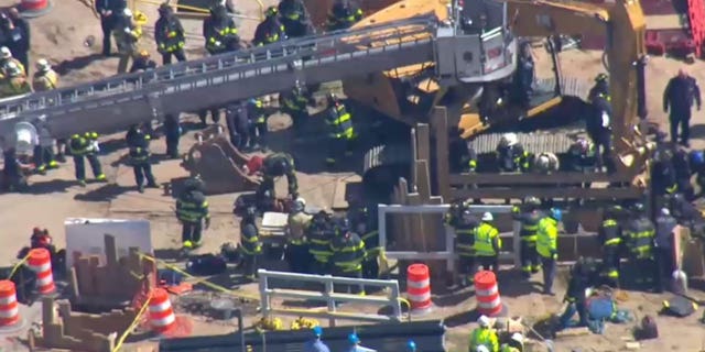The trench at JFK Airport where the two workers became trapped was 30 feet deep, a firefighters union says.