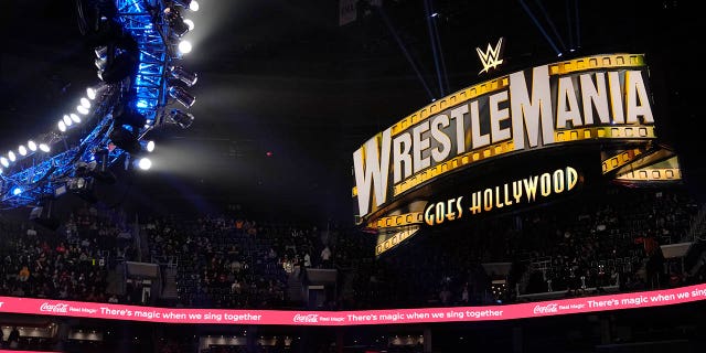 A WrestleMania sign hangs above the crowd during the WWE Monday Night RAW event, Monday, March 6, 2023, in Boston.