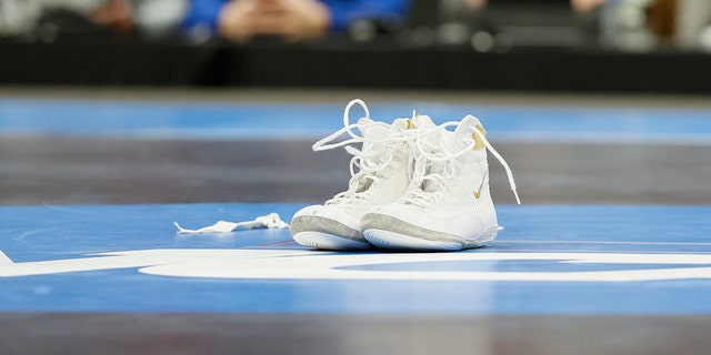 Wrestling shoes sit on the mat