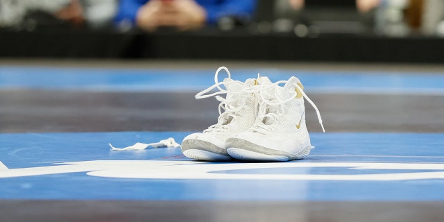 Wrestling shoes sit on the mat