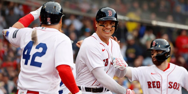 Red Sox's Yu Chang, center, is congratulated by teammates after hitting a two-run homer against the Los Angeles Angels at Fenway Park, Saturday, April 15, 2023, in Boston.