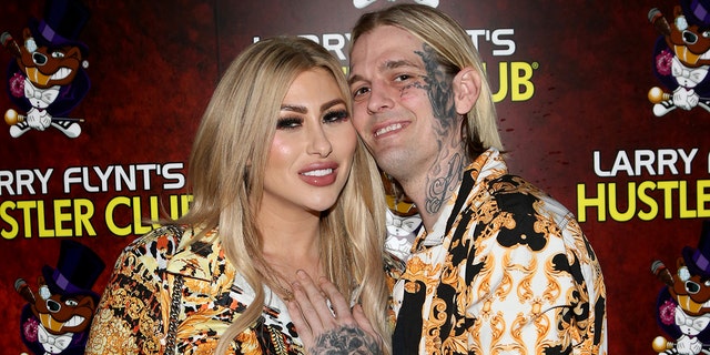 Aaron Carter wears colorful shirt to match fiancee Melanie Martin's dress at event