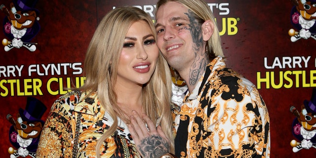 Aaron Carter wears colorful shirt to match fiancee Melanie Martin's dress at event