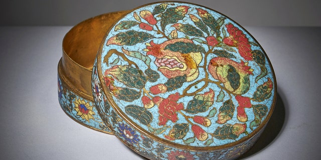 An exceptionally rare Chinese cloisonné "pomegranate" box and cover from the 15th century Ming period has been discovered in a dust-filled cabinet in the attic of a family home, where it had been stored and left untouched since the owner’s death in 1967. 