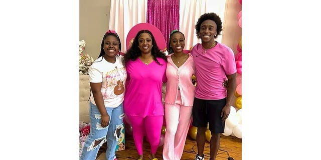 A photograph of the Dowdell family, including Phil (right), who was killed in a mass shooting at a Sweet 16 birthday party in Dadeville, Alabama.