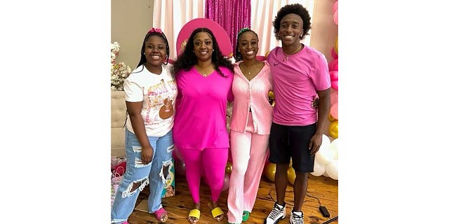 A photograph of the Dowdell family, including Phil (right), who was killed in a mass shooting at a Sweet 16 birthday party in Dadeville, Alabama.