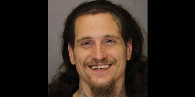 mugshot of a smiling Anthony Santiago