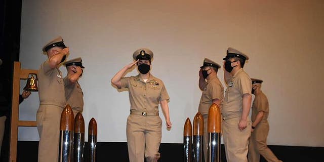 Former Navy sailor Sarah Bils, middle, during a promotion ceremony.