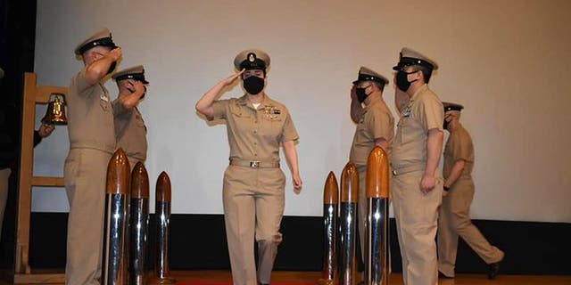 Former Navy sailor Sarah Bils, middle, during a promotion ceremony.