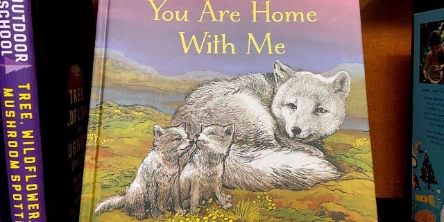 The children's book "You Are Home With Me," illustrated by Mitchell Thomas Watley, is shown at a bookstore in Portland, Oregon, on April 5, 2023. Publisher Sasquatch books said Wednesday it has ended its publishing relationship with Watley.