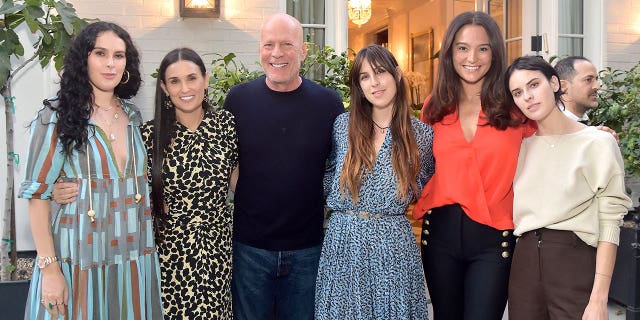 Bruce Willis hugs his daughters and wife Emma Herning at Demi Moore's book launch