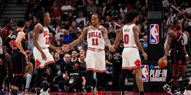 DeMar DeRozan (11) of the Chicago Bulls celebrates with teammates Ayo Dosunmu (12) and Coby White (0) against the Toronto Raptors during the 2023 play-in tournament at the Scotiabank Arena April 12, 2023, in Toronto.