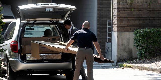 Law enforcement personnel work outside the Orlando Museum of Art on June 24, 2022. A former Los Angeles auctioneer agreed to plead guilty to creating fake Jean-Michel Basquiat artwork which wounded up at the museum.