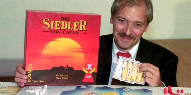 Klaus Teuber, originally a dental technician from Darmstadt, presents his game "The Settlers of Catan" on Sept. 29, 1995, in Frankfurt, Germany. Teuber died on April 1, 2023, at the age of 70.