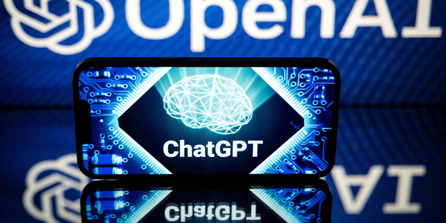 A screen displays the logos of OpenAI and ChatGPT on Jan. 23, 2023.