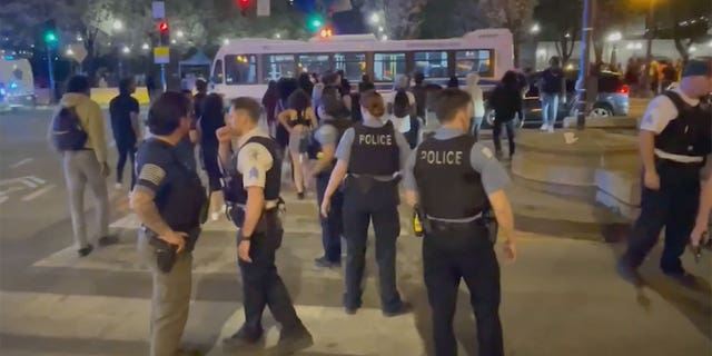 Police attempt to restore order in downtown Chicago after hundreds of teens descended on the area Saturday night.